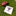 A white fringed rally towel with maroon text and a cartoon football player graphic lies on green grass next to a brown leather football.