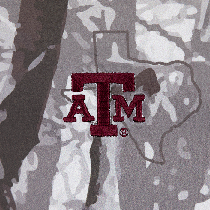 Zoomed in ATM logo in maroon on woodlands camo polo