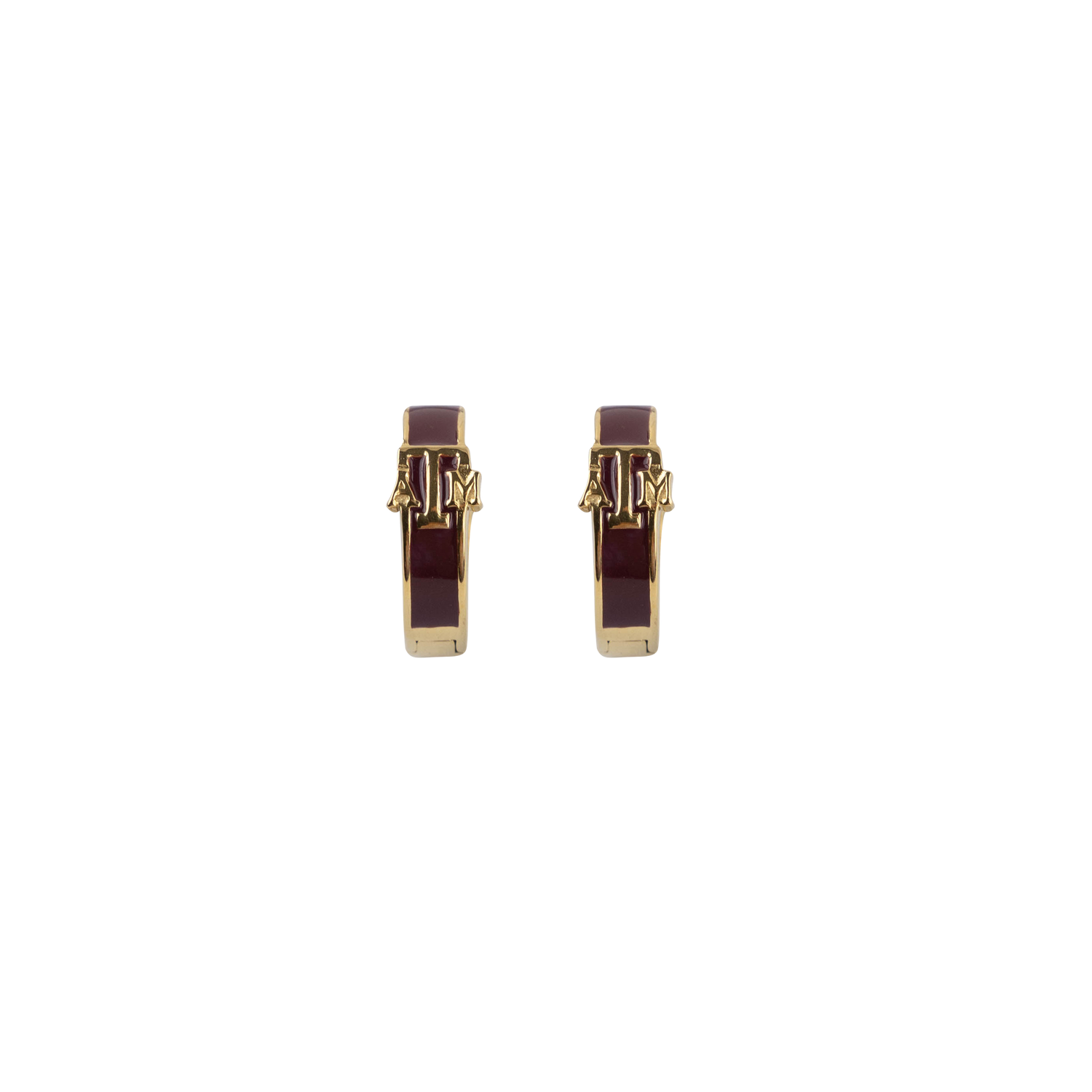 A pair of gold-toned huggie earrings with a dark burgundy enamel center and gold ATM logo shown on a plain white background.