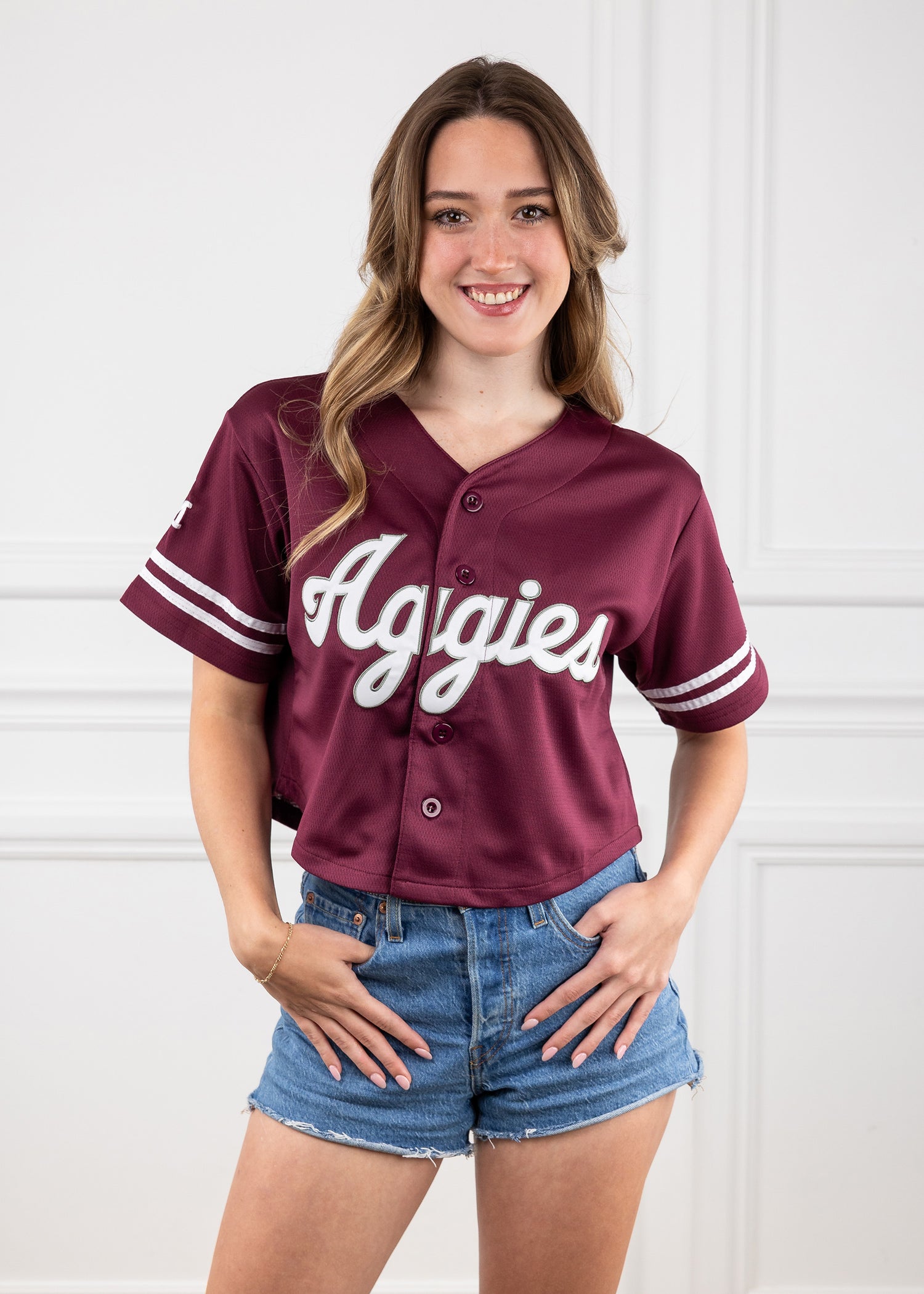 Maroon cropped jersey with script "Aggies" in white across the chest