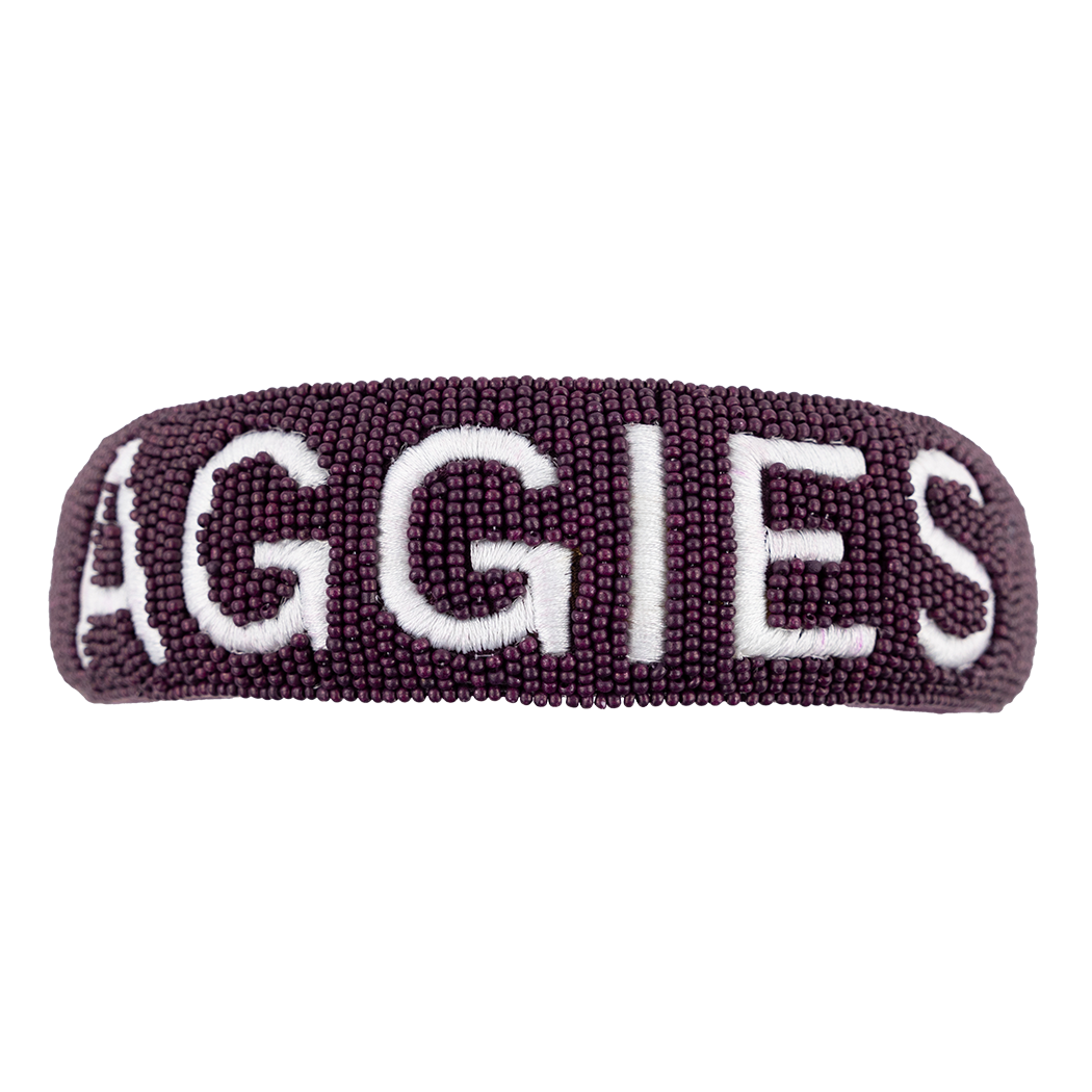 A maroon beaded headband. AGGIES is spelled out in white thread. 