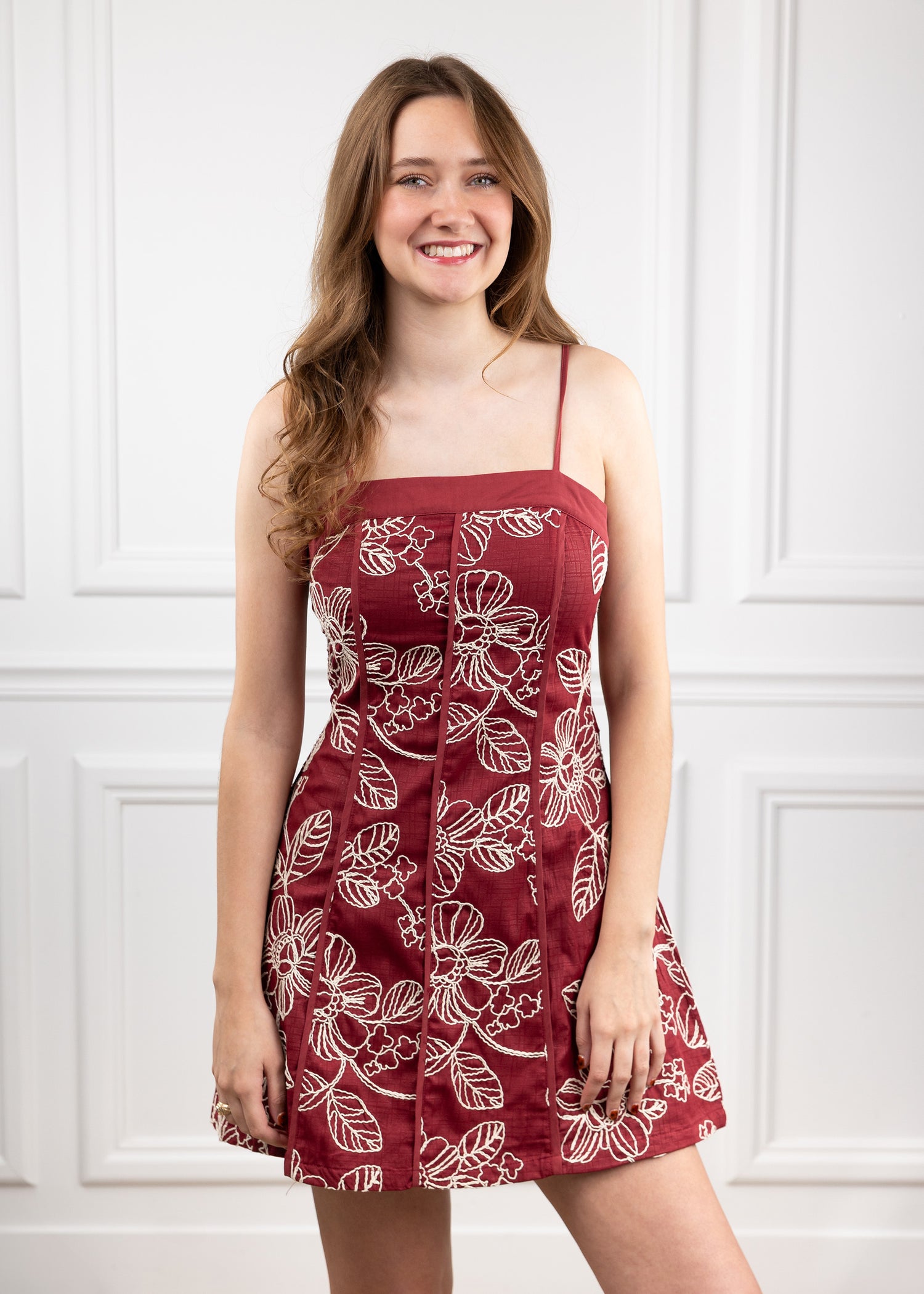 Woman wearing a maroon floral dress