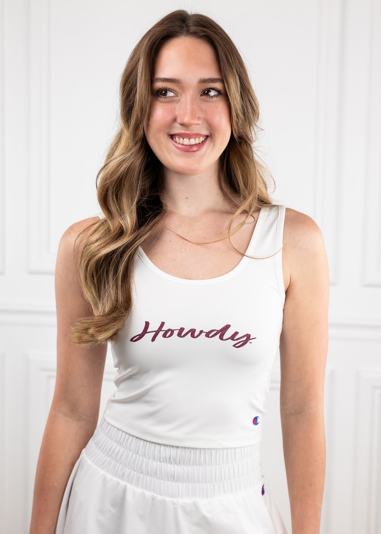 women white tank top with "Howdy" in script maroon in the center of the shirt.