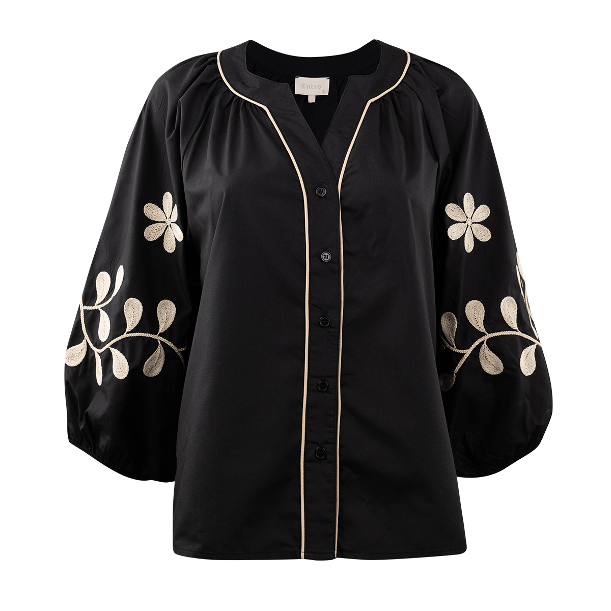 Black blouse with floral embroidery in a light cream.