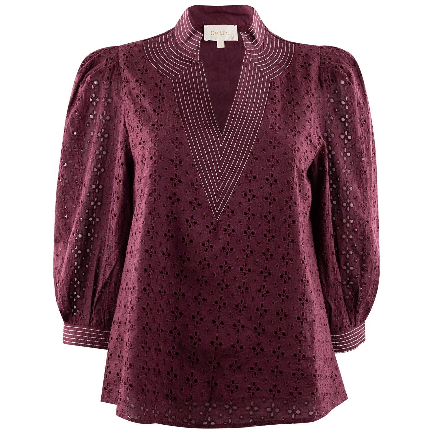 Maroon eyelet blouse with long sleeves, a high stand collar, V-neckline, and white embroidered stripe detailing around the collar and neckline. Features an allover floral eyelet pattern and striped cuffs.
