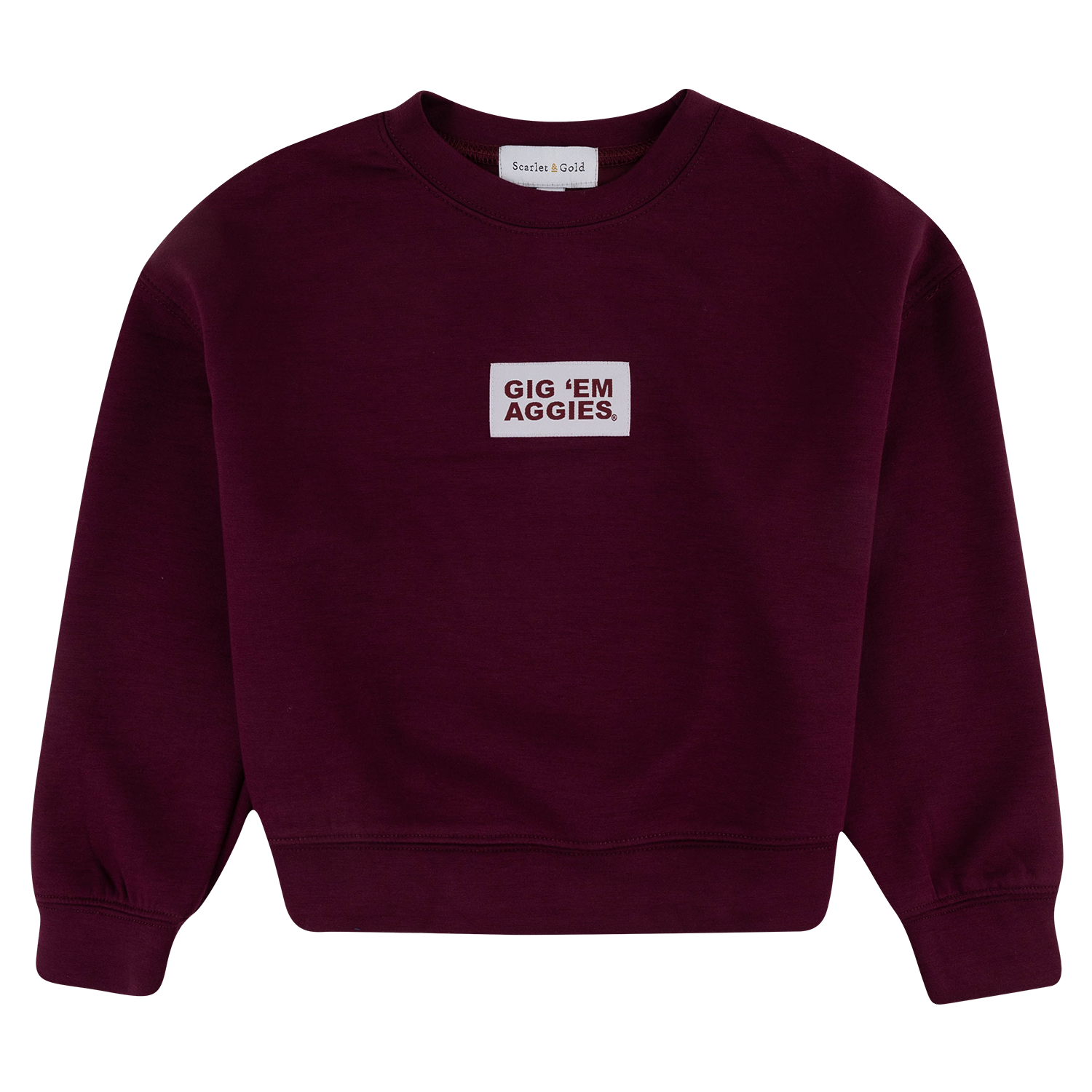 A maroon crewneck sweatshirt with a white rectangular patch on the chest that reads 'GIG 'EM AGGIES.' in maroon  text.