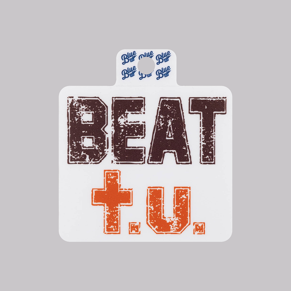 Sticker in maroon and orange that says "BEAT t.u."