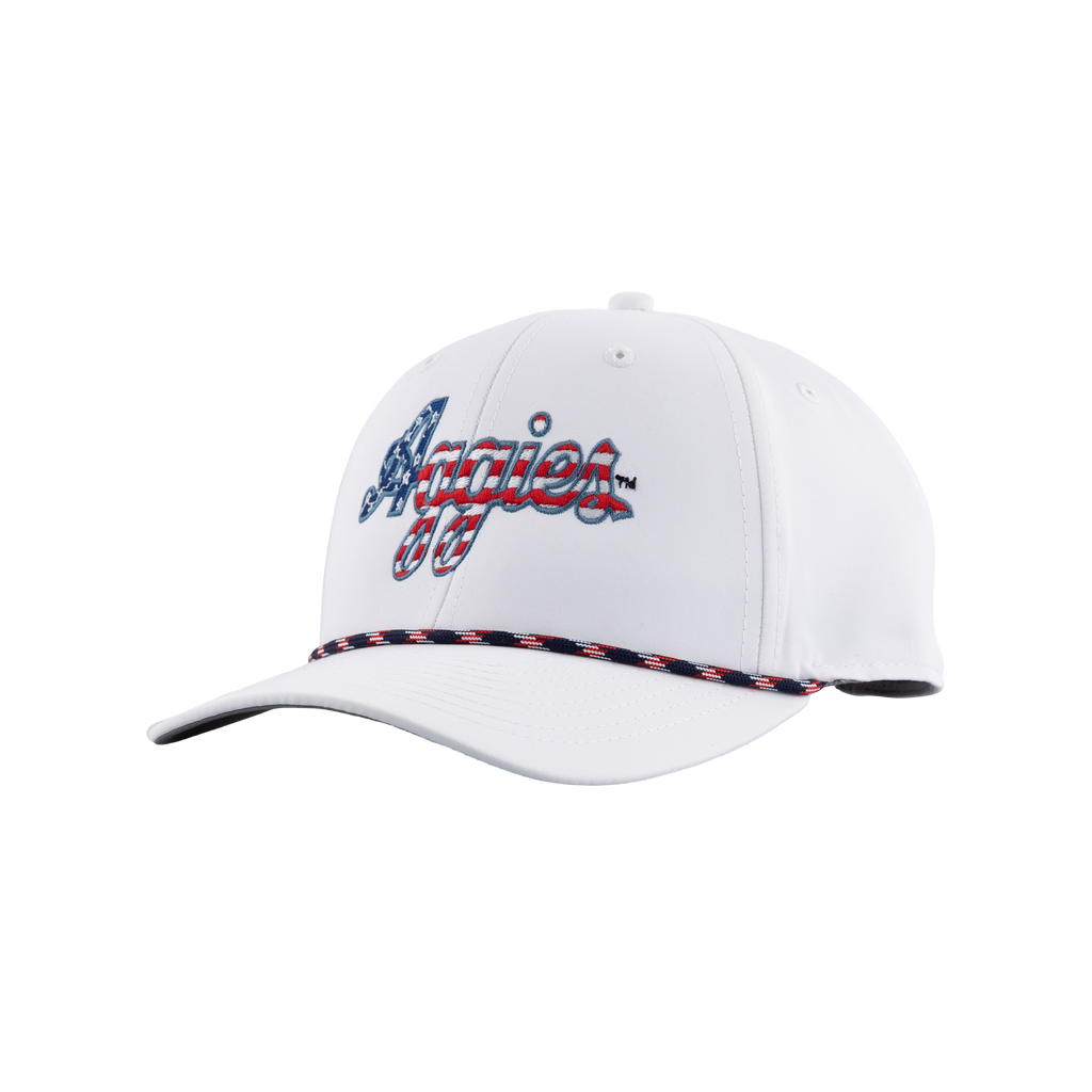 White Texas A&M cap featuring embroidered “Aggies” lettering in blue and red with a decorative red, white, and blue braided trim along the bill.