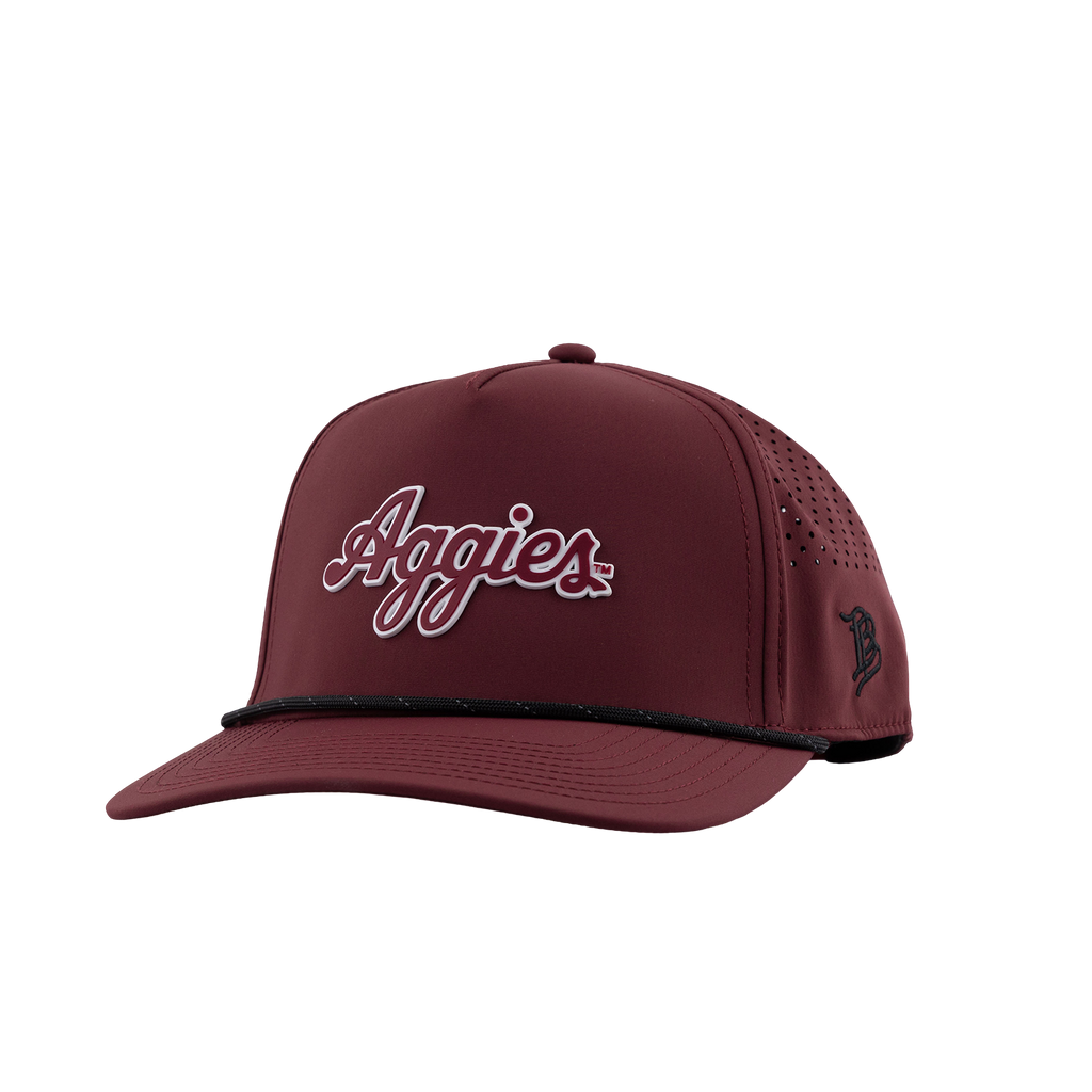 Maroon Texas A&M trucker hat featuring a white and maroon “Aggies” script logo, perforated side panels, black trim, and a black embroidered logo on the side.