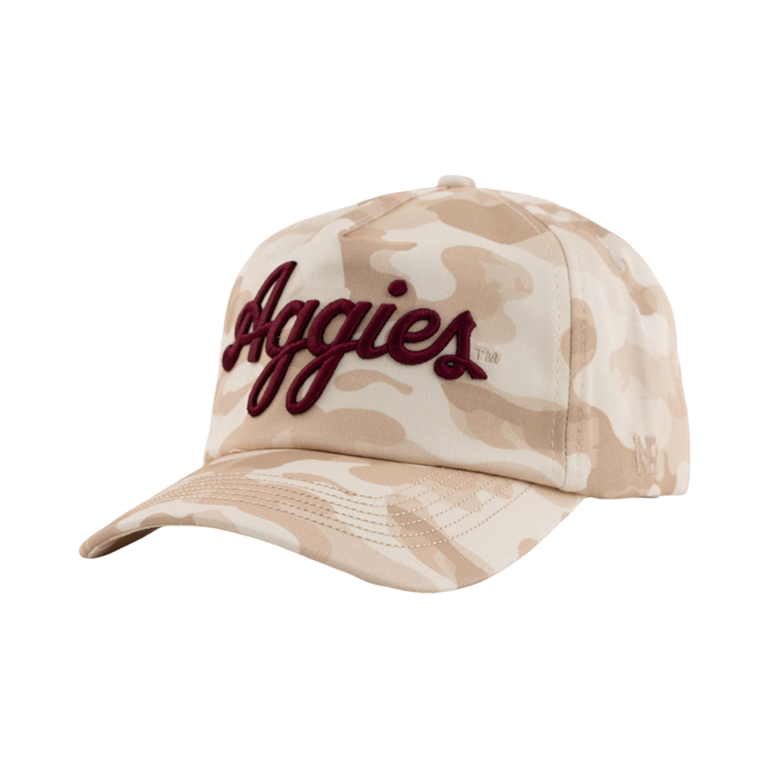 A beige desert camouflage baseball cap featuring maroon script text on the front reading "Aggies".  