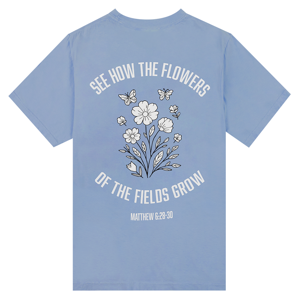 Blue T-Shirt with White Flowers Quoting Matthew 6:28-30