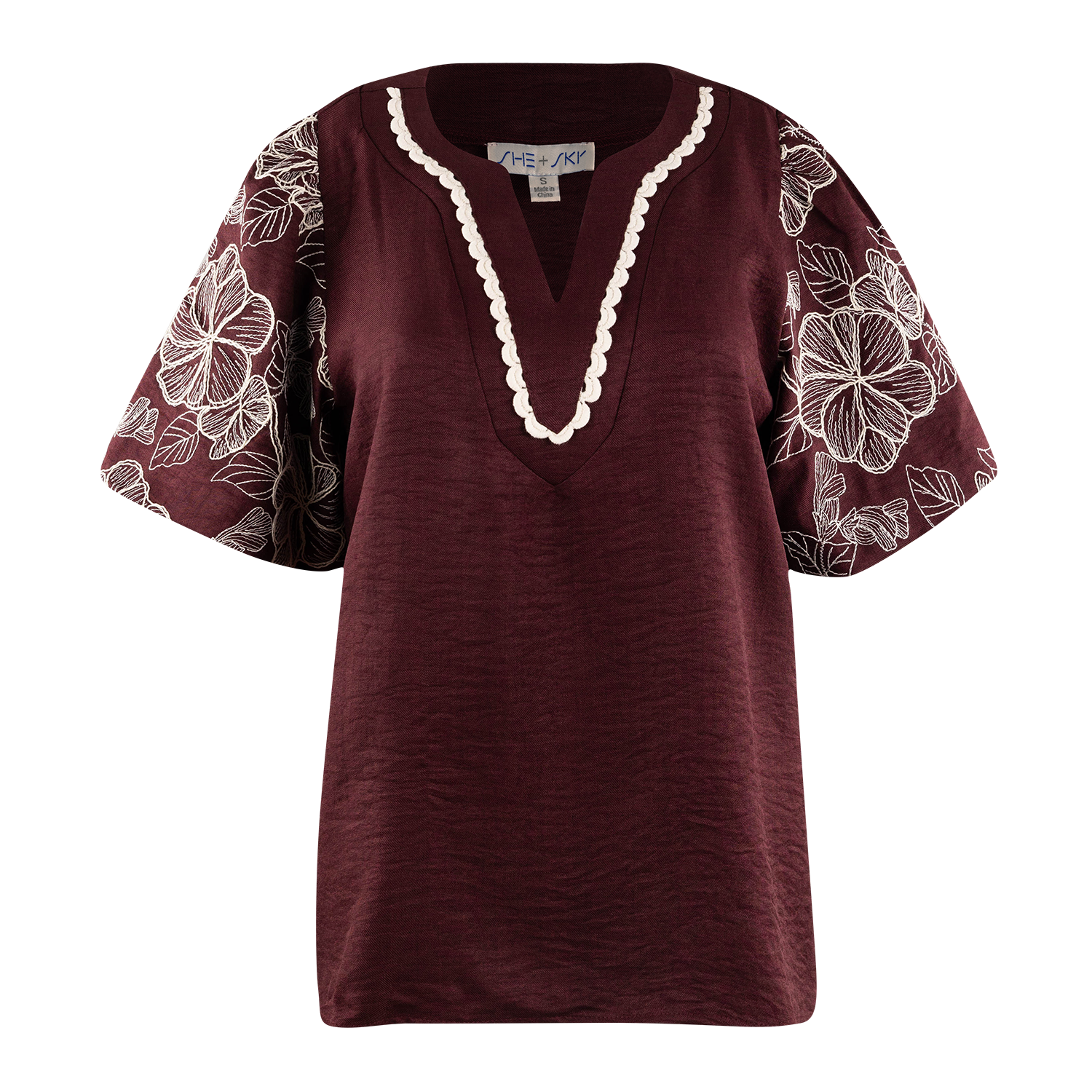 A women's short-sleeve top in deep burgundy with a scalloped cream V-neck trim and white floral embroidery on the sleeves, shown against a plain white background.