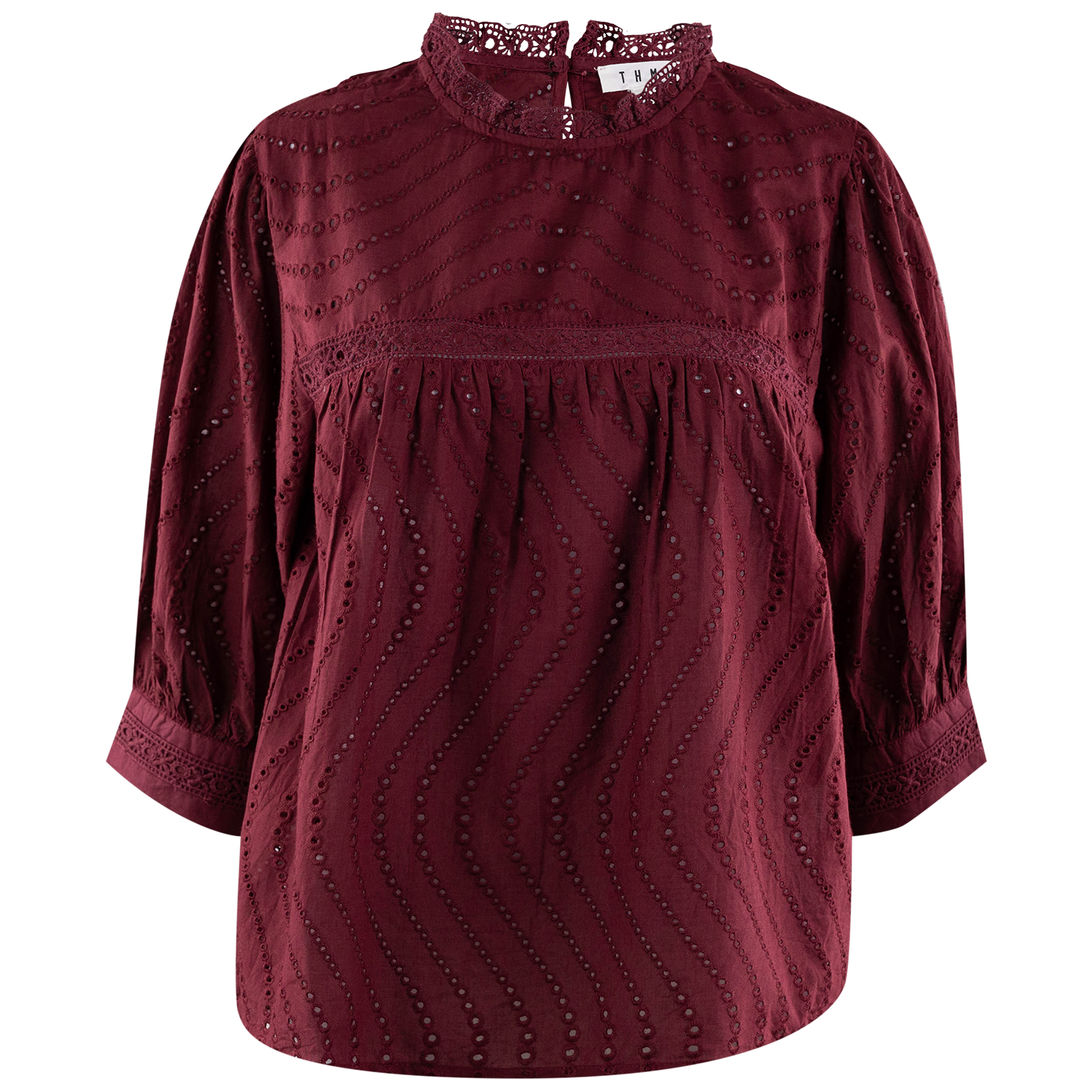 A burgundy eyelet blouse with a mock neck, 3/4 sleeves, and a gathered waist, shown against a plain white background.