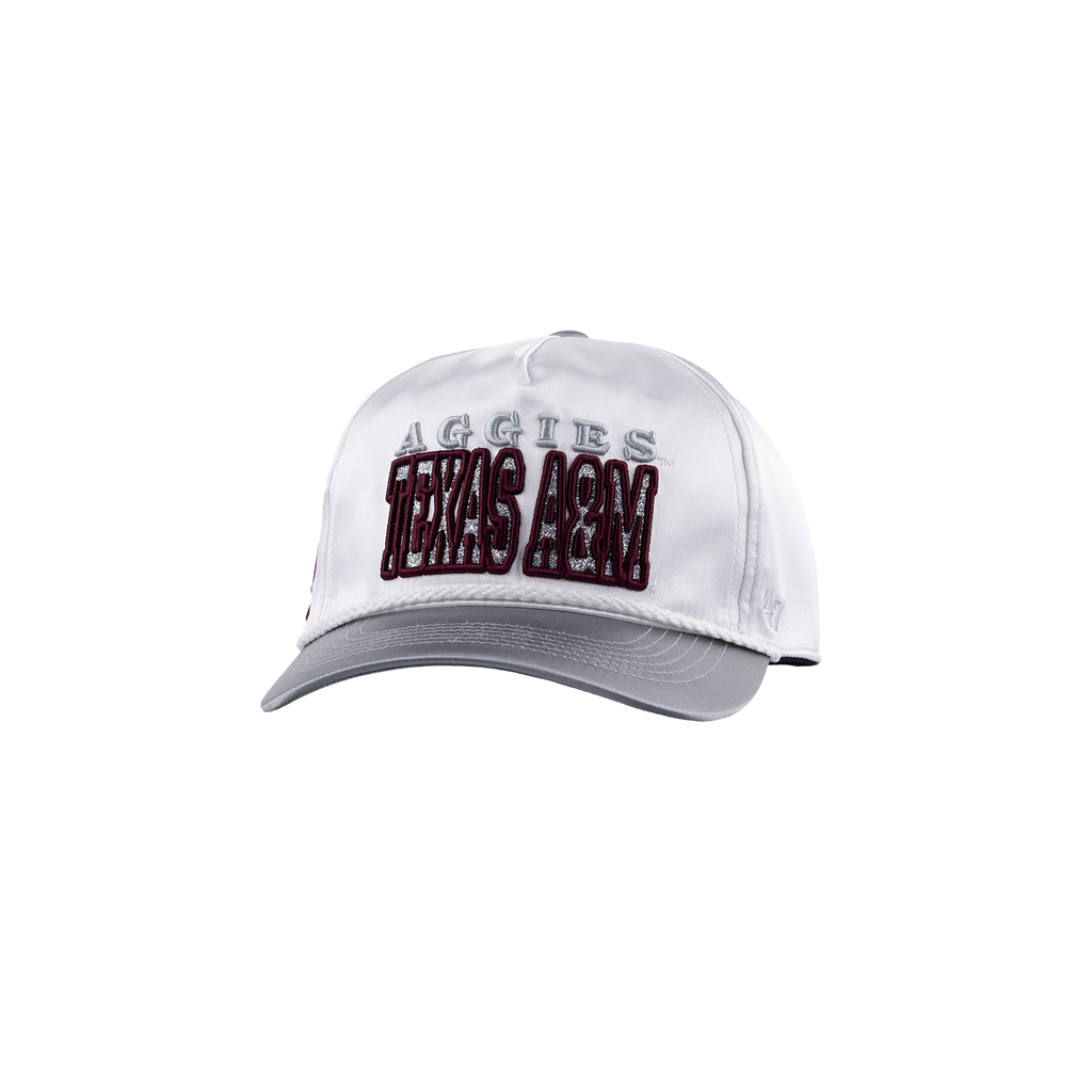 A white baseball cap with a gray visor and gray embroidered 'AGGIES' text above large maroon and white 'TEXAS A&M' lettering on the front.
