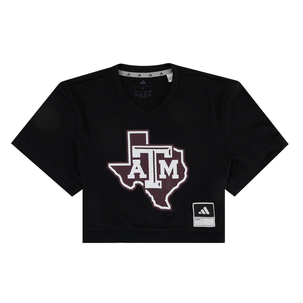 A black short-sleeve cropped V-neck t-shirt featuring a large Texas A&M 'A&M' logo in maroon and white on the front, with an Adidas brand patch on the lower right hem.