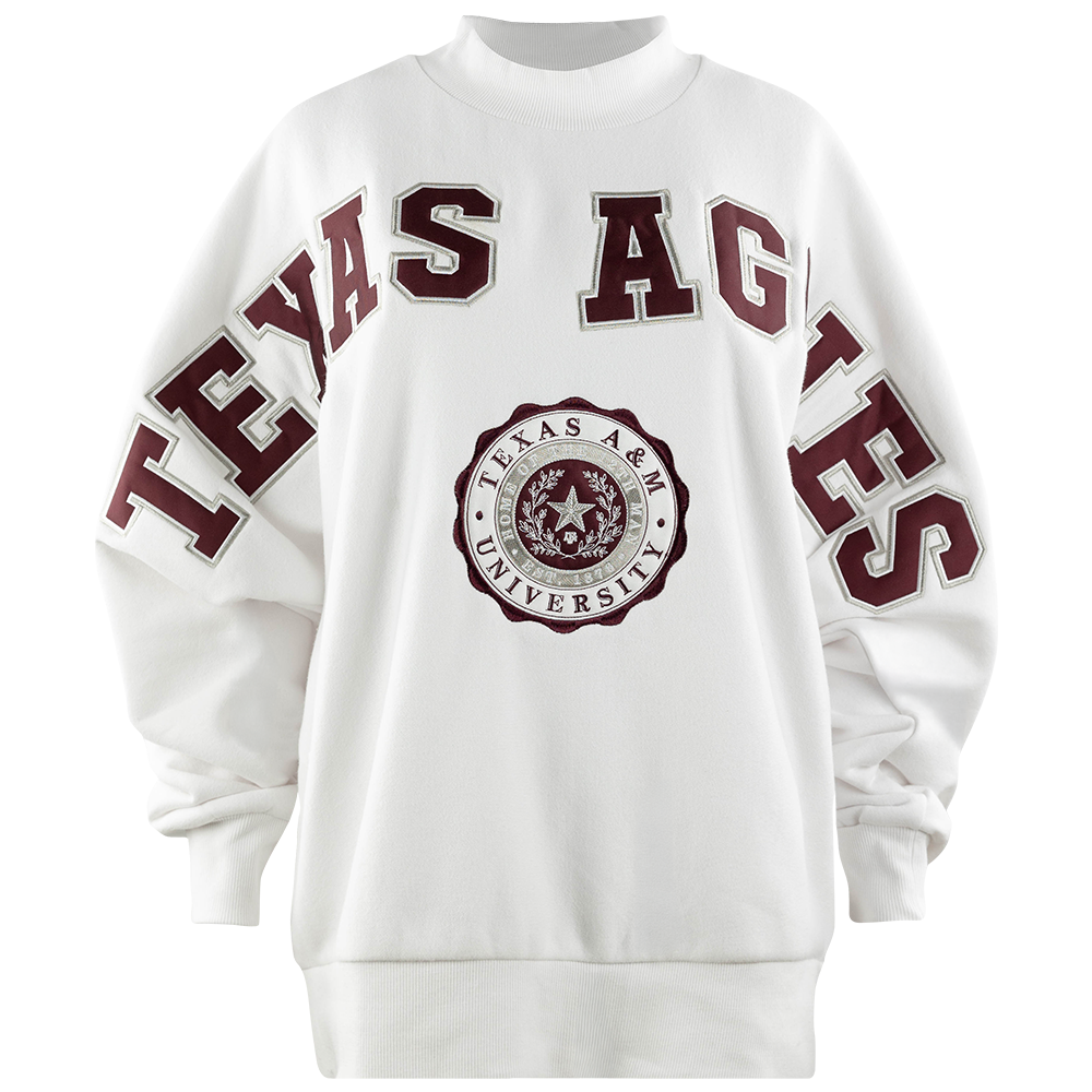 White sweatshirt with "TEXAS AGGIES" in maroon across the front and sleeves. A Texas A&M University Seal is beneath the lettering
