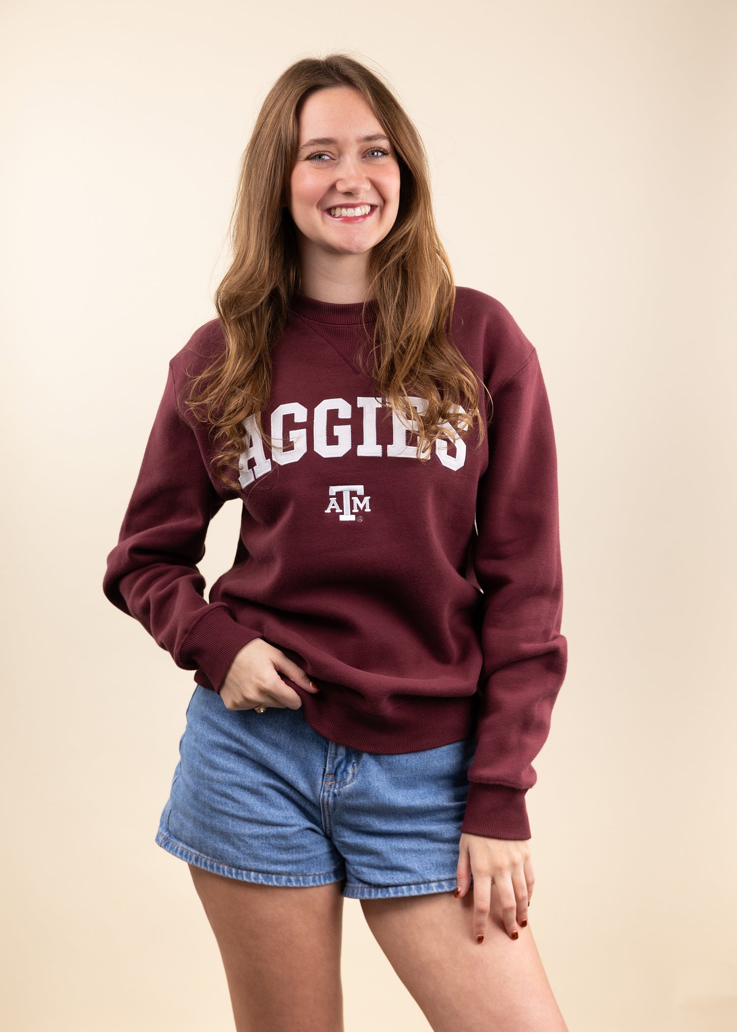 Person wearing a maroon 'AGGIES' sweatshirt.
