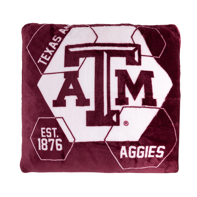 Maroon plush square pillow with white hexagon shapes and an ATM logo and "Texas A&M Aggies"