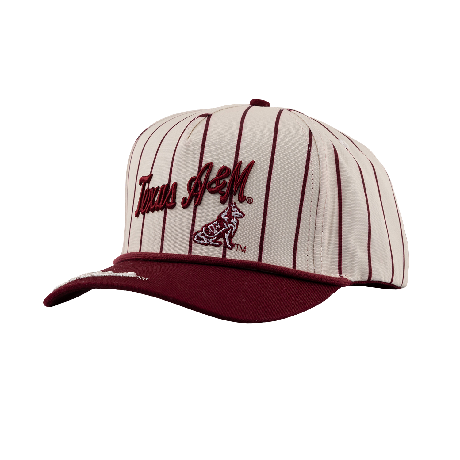 Cream and maroon Texas A&M snapback cap with pinstripe pattern, script "Texas A&M" logo, and Reveille mascot embroidery above a maroon brim.