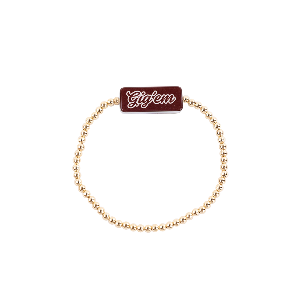 Gold beaded bracelet with a red tag displaying 'Gigem' 