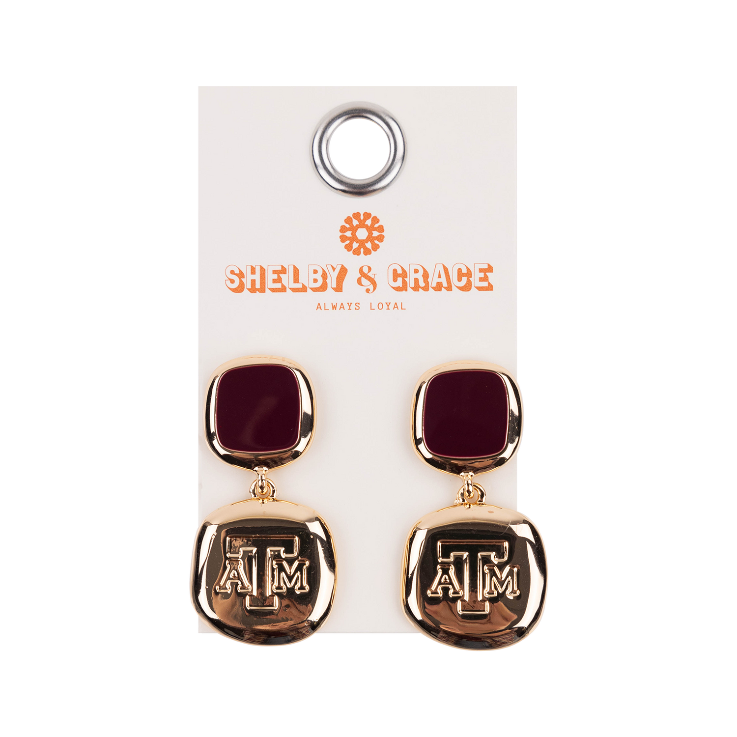 Maroon and gold square earrings with ATM logos.