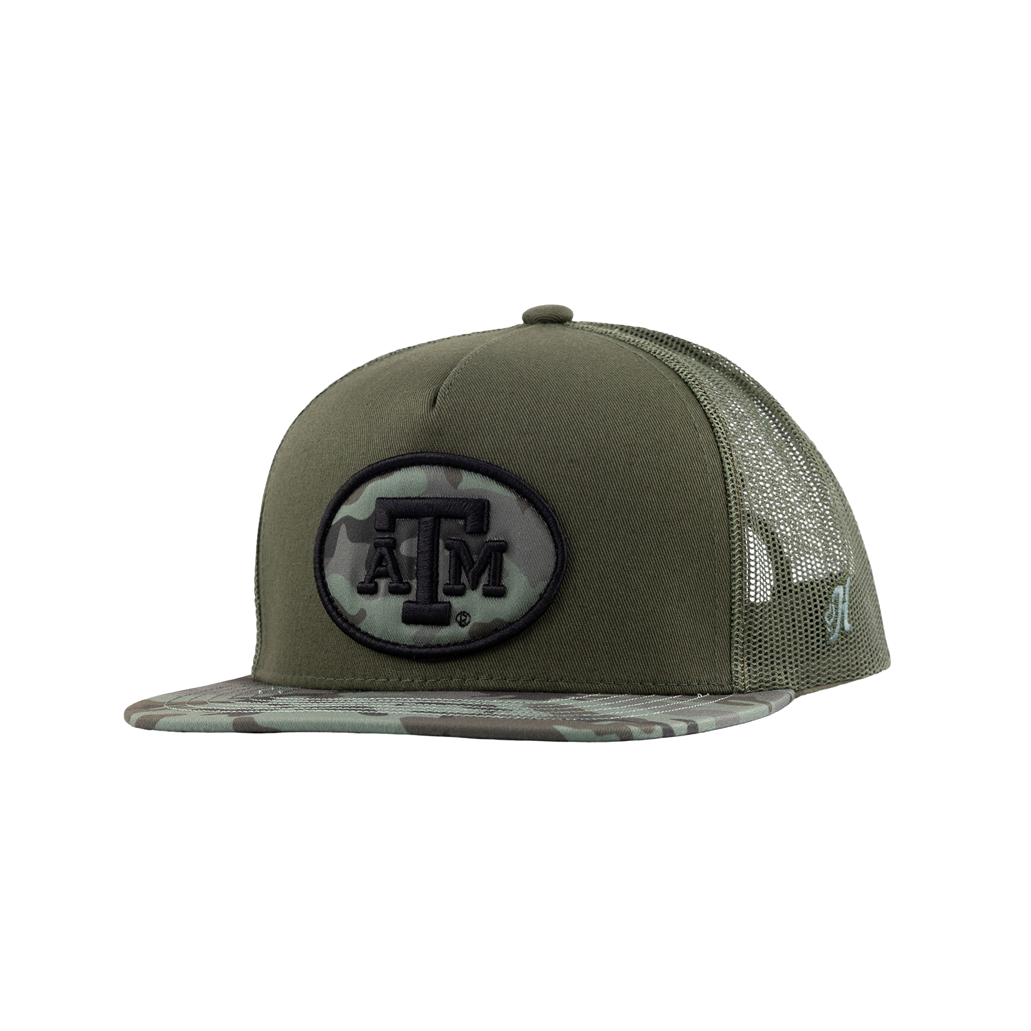 An olive green trucker hat with a camouflage-patterned brim and mesh back, featuring a black and camouflage oval patch with the Texas A&M 'A&M' logo on the front.