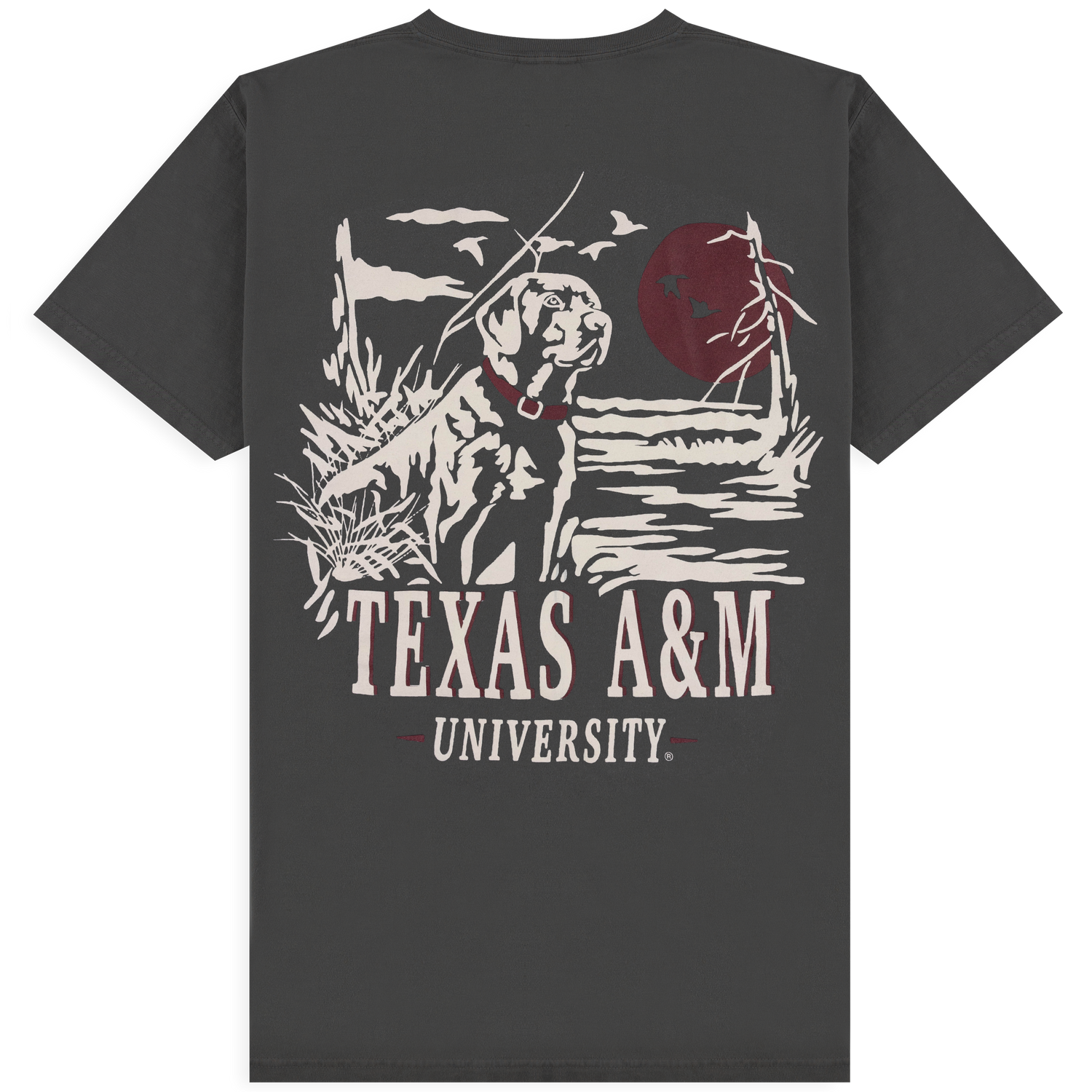 Texas A&M University T-shirt in charcoal gray featuring a vintage-style graphic of a dog wearing a maroon collar against a sunset with birds and marsh grass.