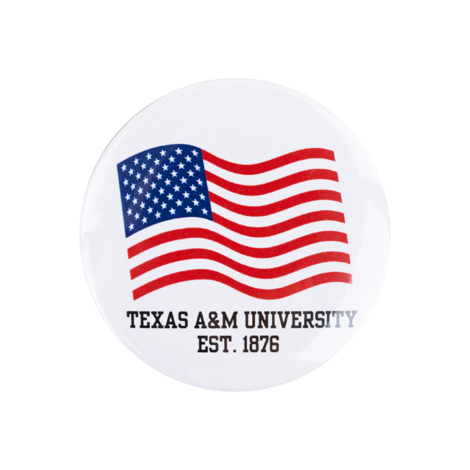 A round white button pin featuring a waving American flag with red and white stripes, a blue field with white stars, and the text 'TEXAS A&M UNIVERSITY EST. 1876' printed below.