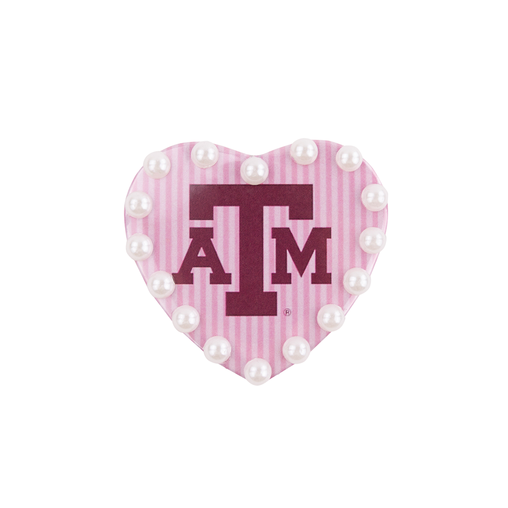 Heart-shaped pink and white striped magnet with 'ATM' logo and pearls