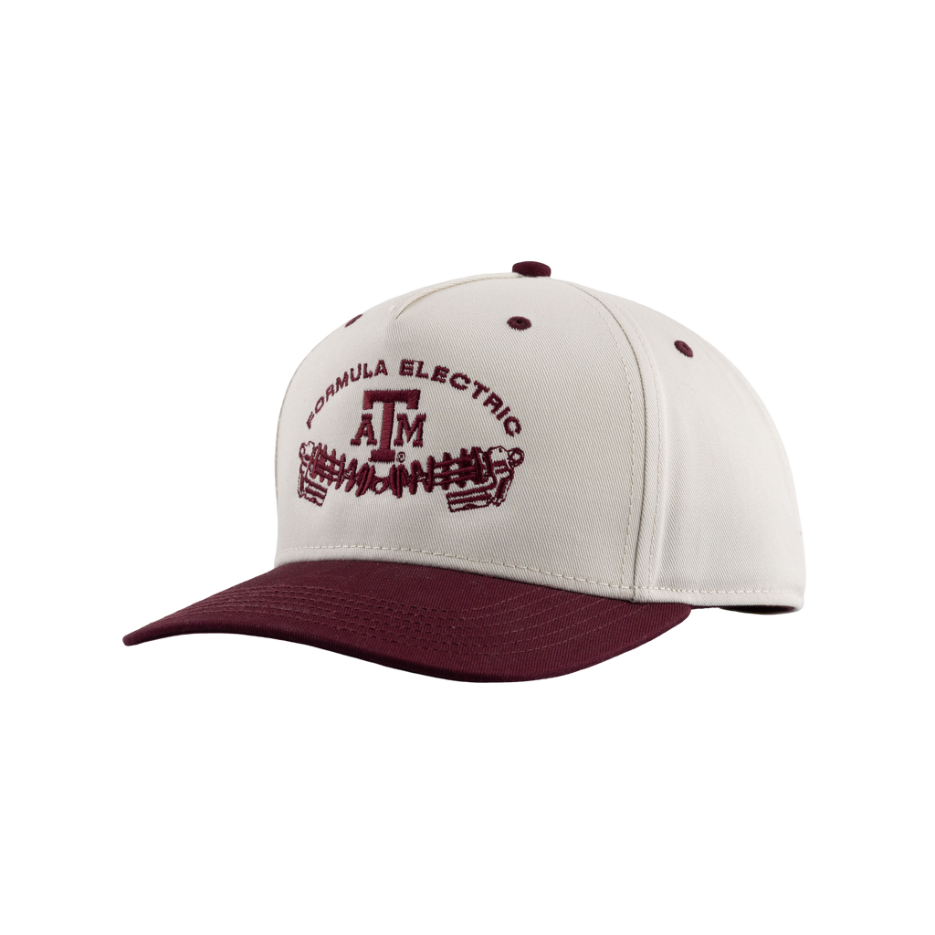 Two-tone snapback cap with a cream crown and maroon brim, embroidered on the front panel with a maroon 'Formula Electric' text arched above a Texas A&M 'ATM' logo, sitting above a graphic of an electric motor or gear-and-coil assembly.