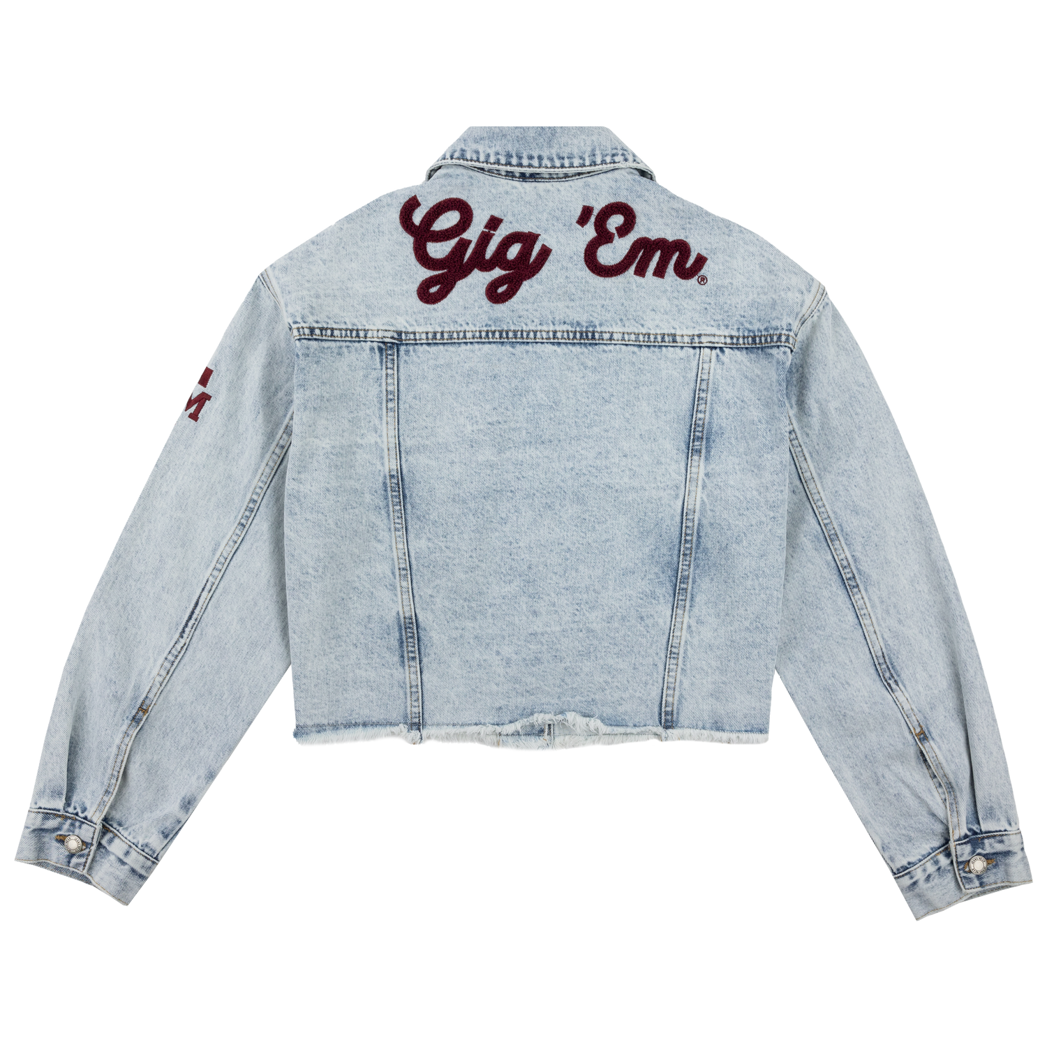 A light blue cropped denim jacket with Gig 'Em printed in maroon cursive font across the back. 