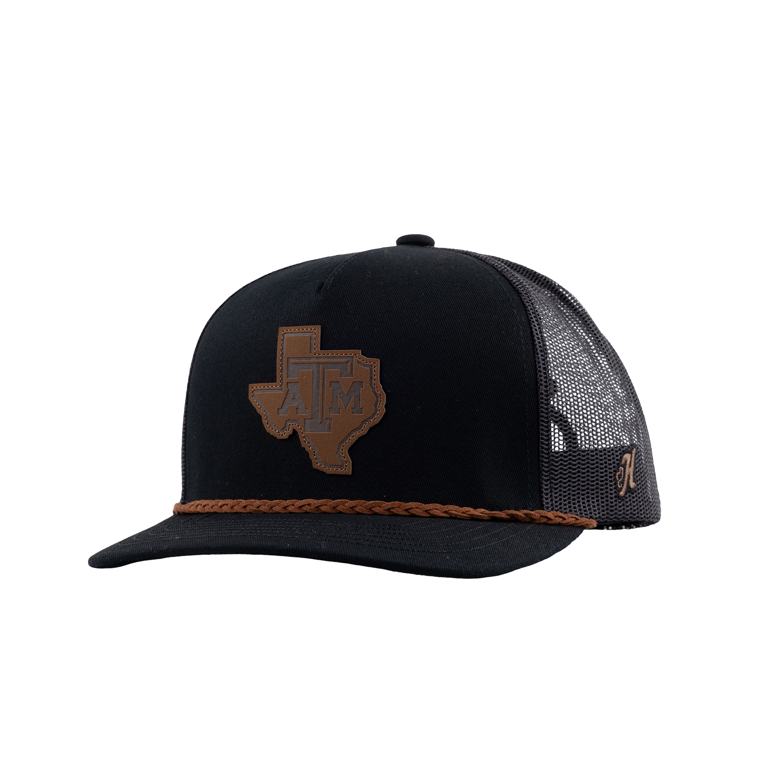 A black trucker hat with a brown leather Texas A&M patch on the front, a braided brown leather cord detail along the brim, and a brown mesh back with Gig 'Em embroidery.