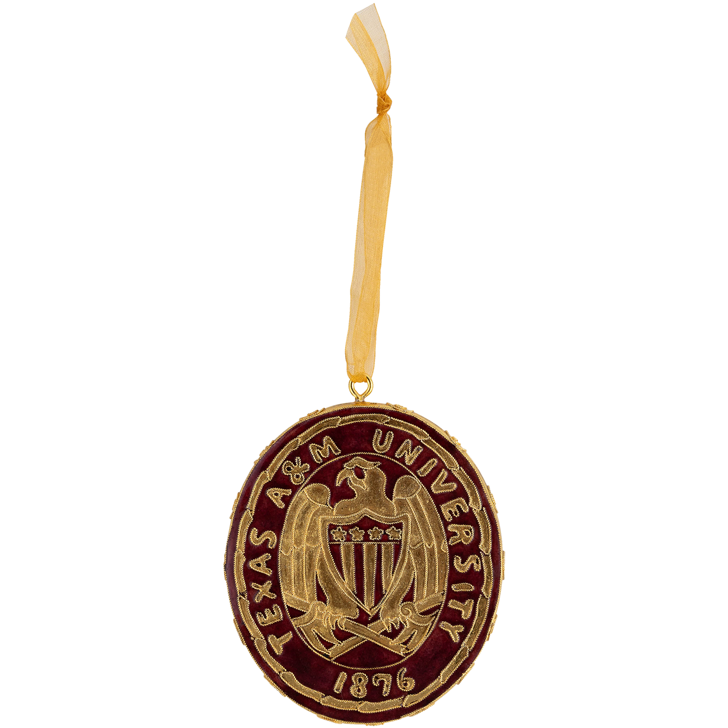 A circular Texas A&M University ornament featuring a gold crest and lettering on a dark burgundy background, suspended by a sheer gold ribbon against a plain white background.