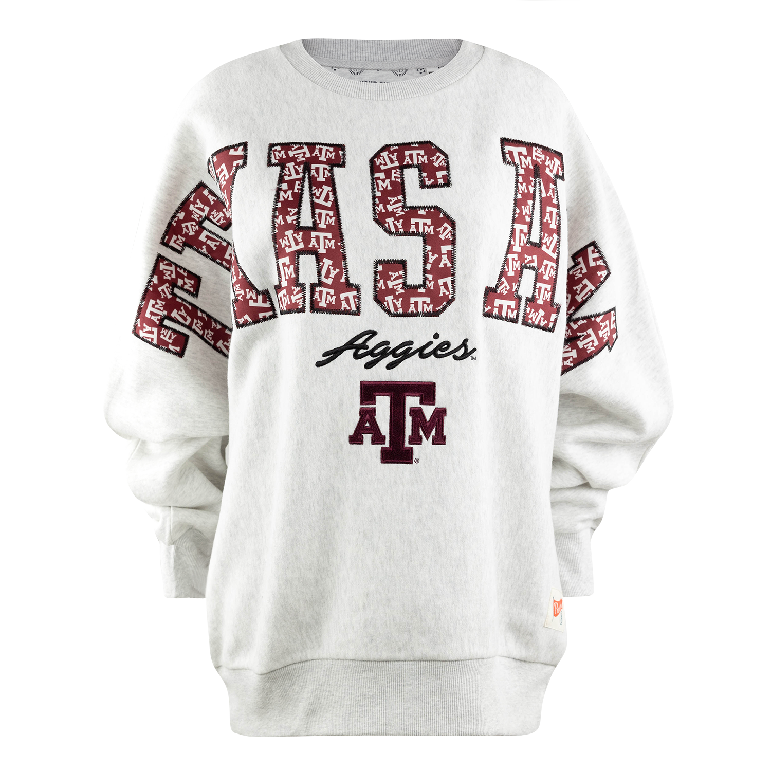 Grey oversized pullover with Texas A&M across the front in a patchwork style filled with the ATM logo. Underneath reads aggies in script and the Texas A&M logo. 