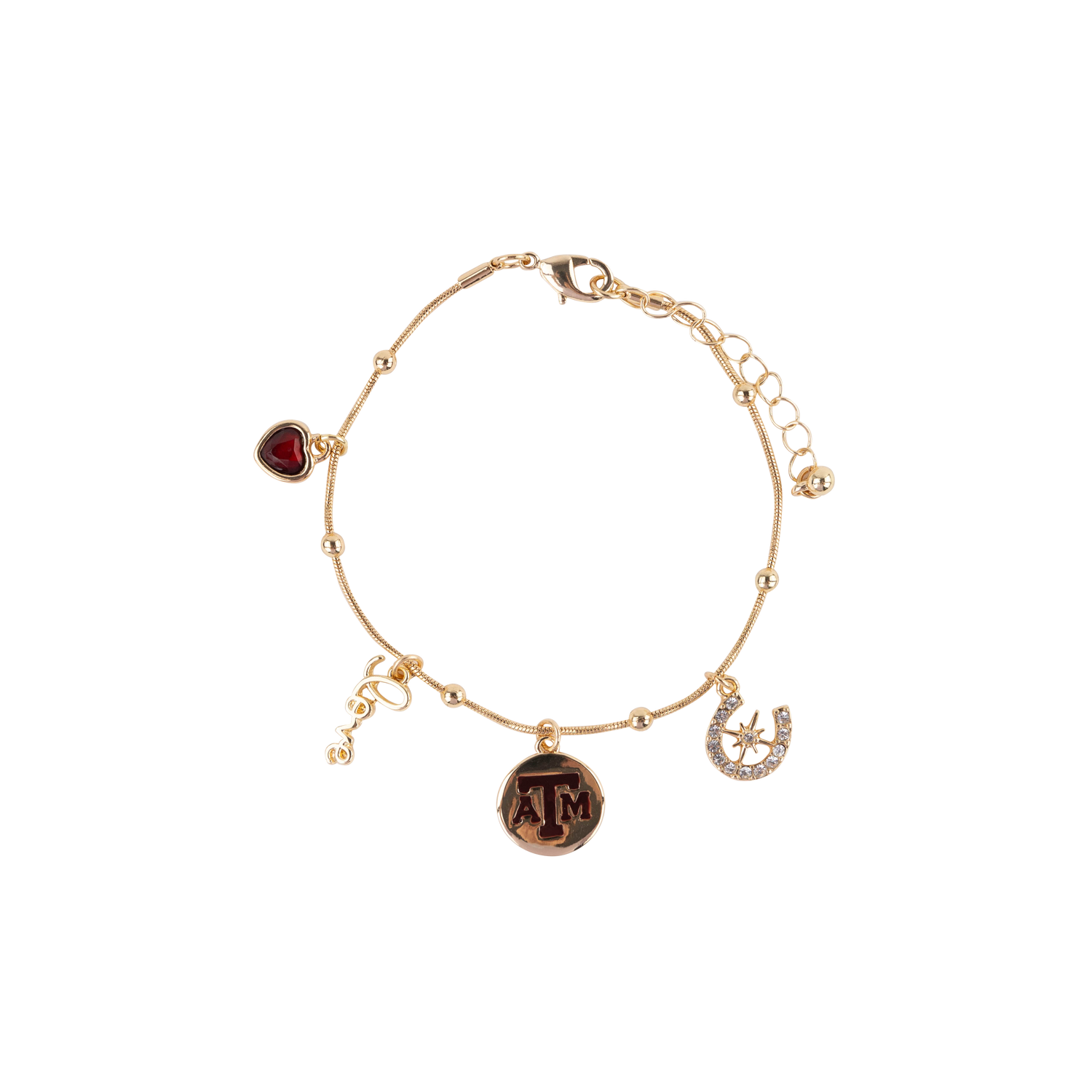 A gold-tone charm bracelet featuring a heart-shaped maroon gemstone, a round 'ATM' charm, a horseshoe with a star, and a small dangling 'love' charm, displayed on a clean white background.