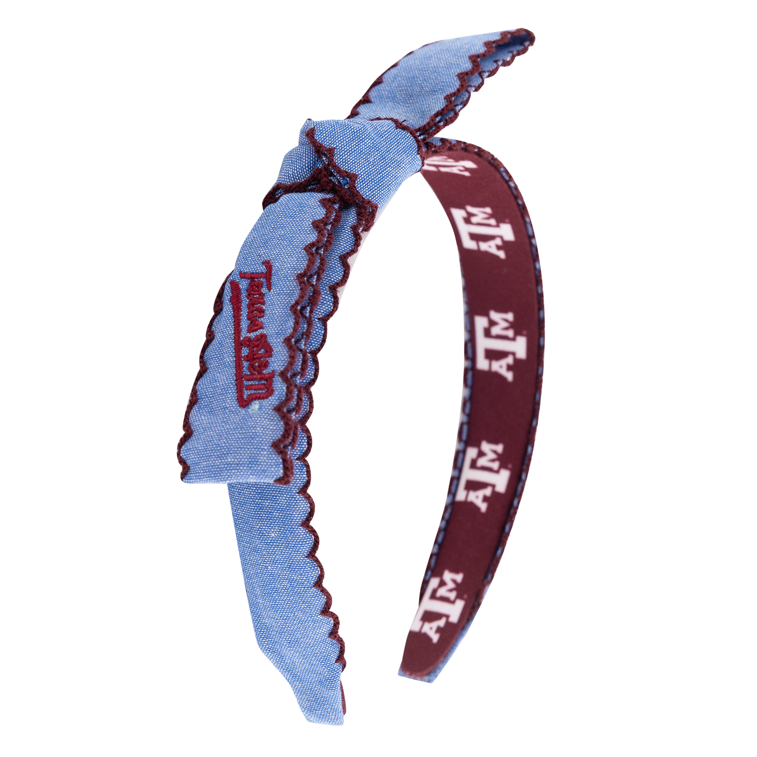A fabric headband featuring a light blue denim-like front strap with a scalloped edge, embroidered maroon Texas A&M logo, and a burgundy inner band printed with white Texas A&M letters.