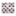 Gray wrapping paper with maroon Santa hats with the Texas A&M logo in white.