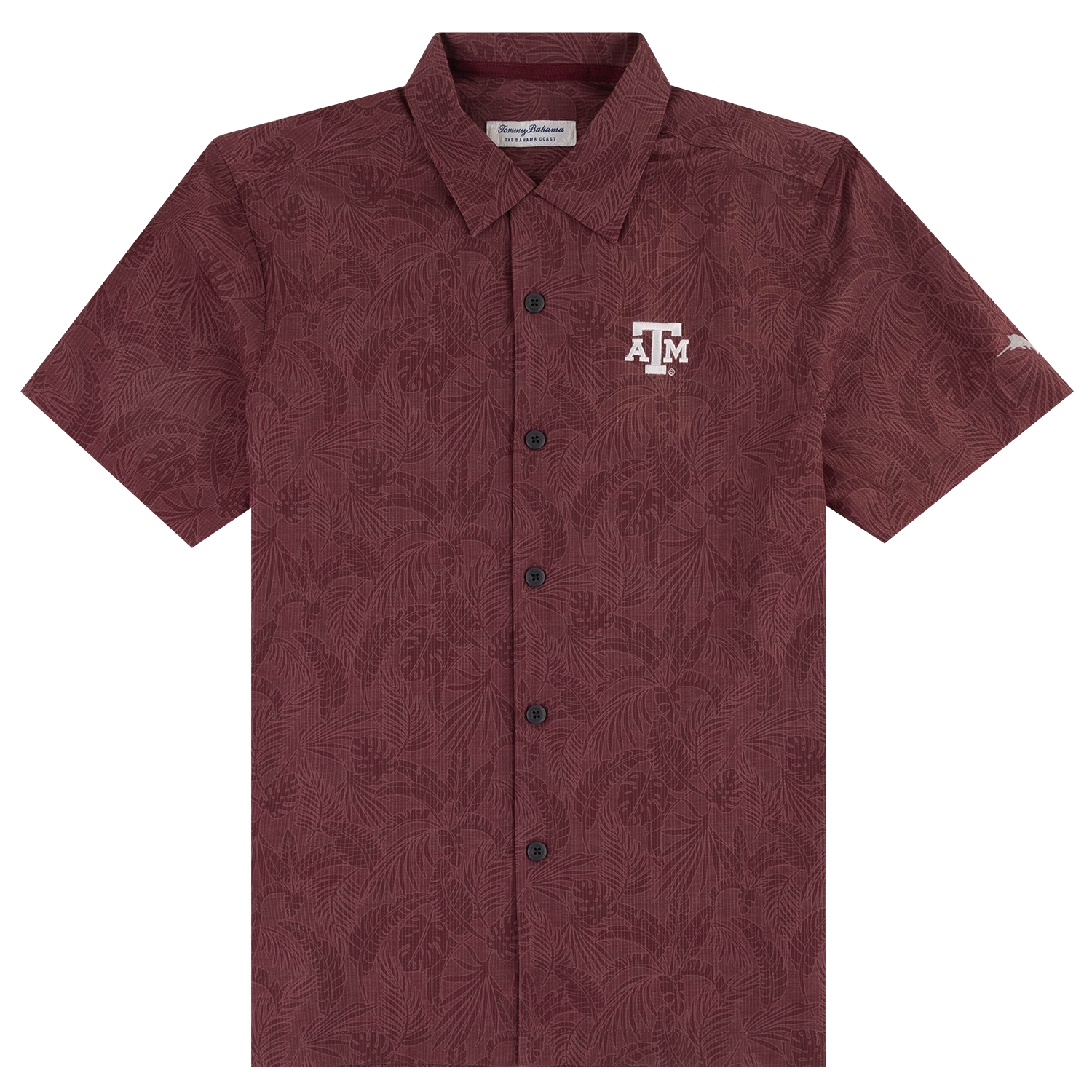 A short-sleeve button-up camp shirt in maroon with an all-over tonal tropical leaf pattern, featuring a white Texas A&M Aggies logo on the left chest.