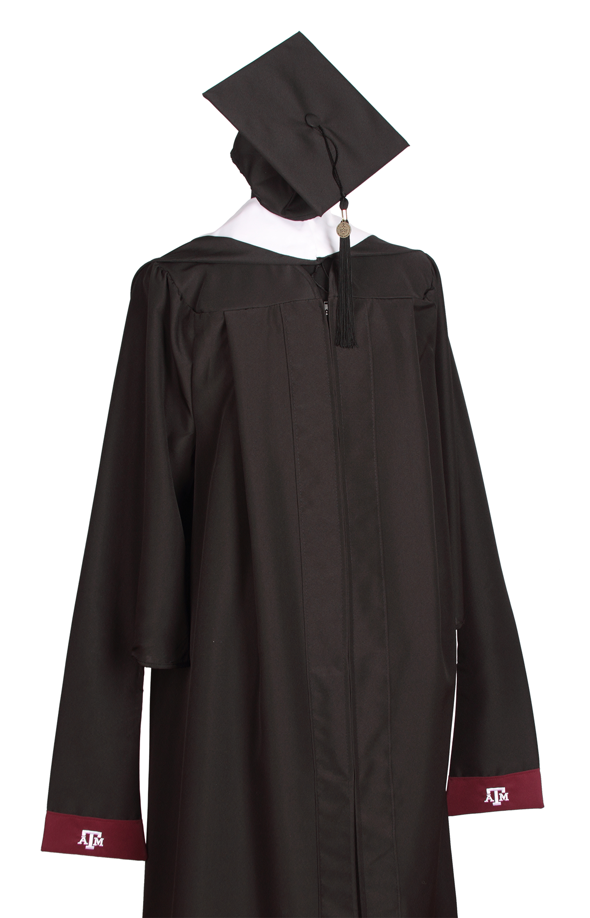 Texas A&M black master’s graduation gown and cap with a black tassel, and maroon sleeve cuffs featuring white Texas A&M logos.