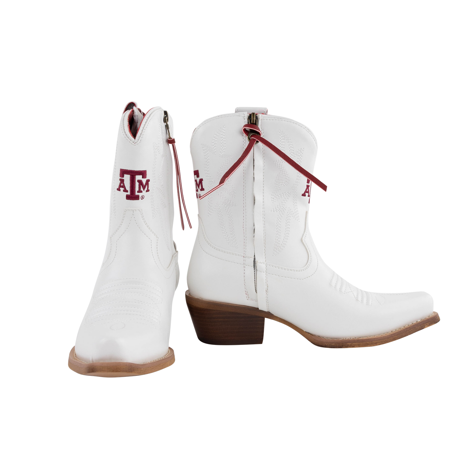 A pair of white leather cowboy boots with a maroon 'A&M' logo on the shaft, featuring side zippers and brown stacked heels, shown against a plain white background.