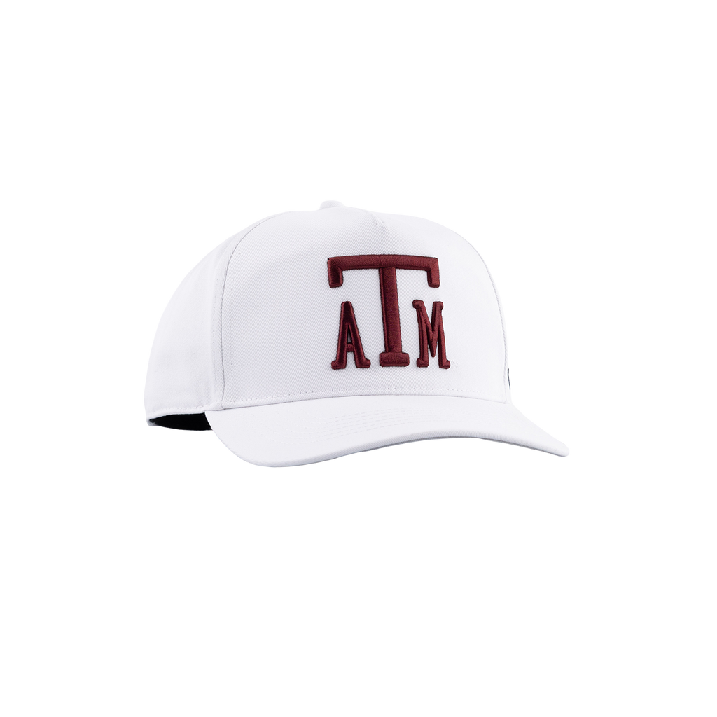 A white baseball cap featuring a dark maroon embroidered 'ATM' logo on the front, representing the Texas A&M University brand, set against a plain white background.