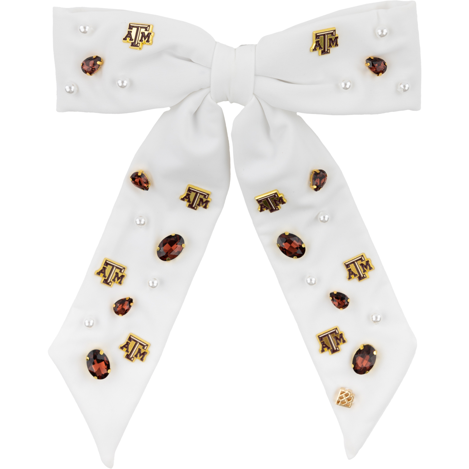 A white hair bow with pearls, maroon gems, and A&M charms scattered throughout