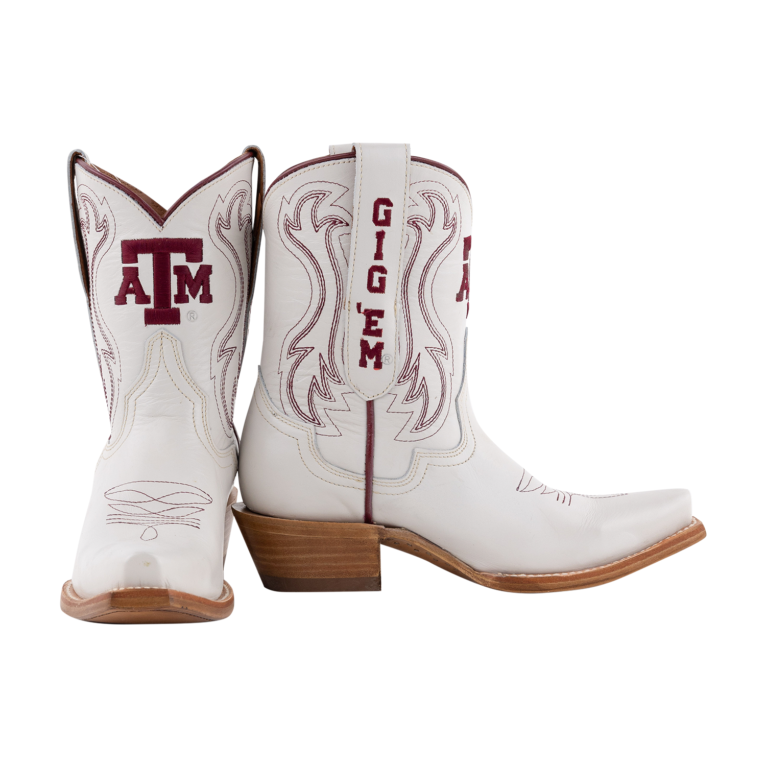 White Texas A&M ankle cowboy boots featuring maroon A&M logos, maroon stitched detailing, and a stacked brown heel.