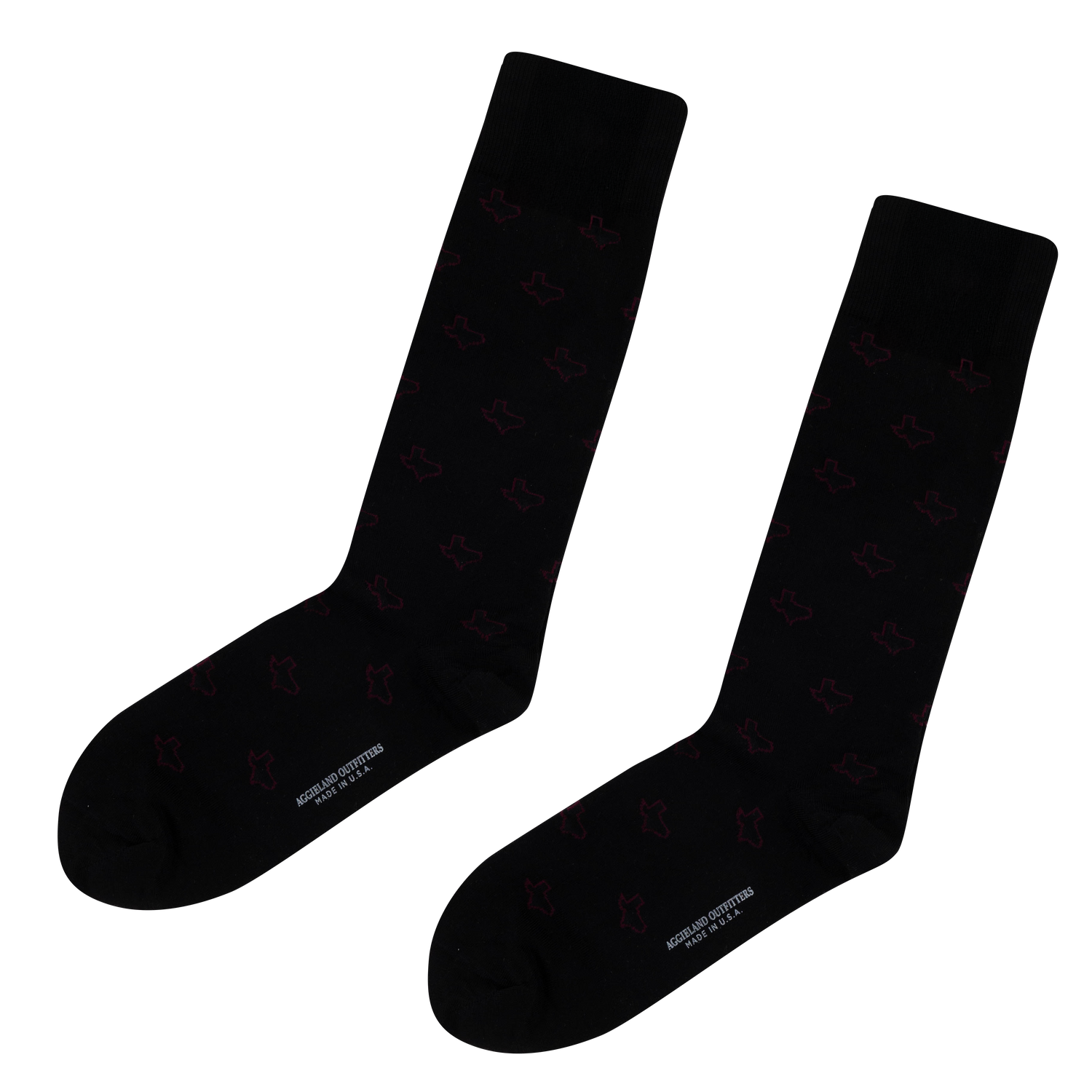 Pair of black crew socks featuring a subtle, repeating maroon state of Texas outline pattern throughout, with "AGGIELAND OUTFITTERS MADE IN U.S.A." printed in white along the bottom sole.   