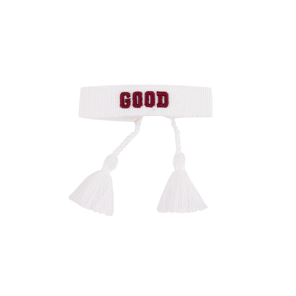 White headband with 'GOOD' text and tassels