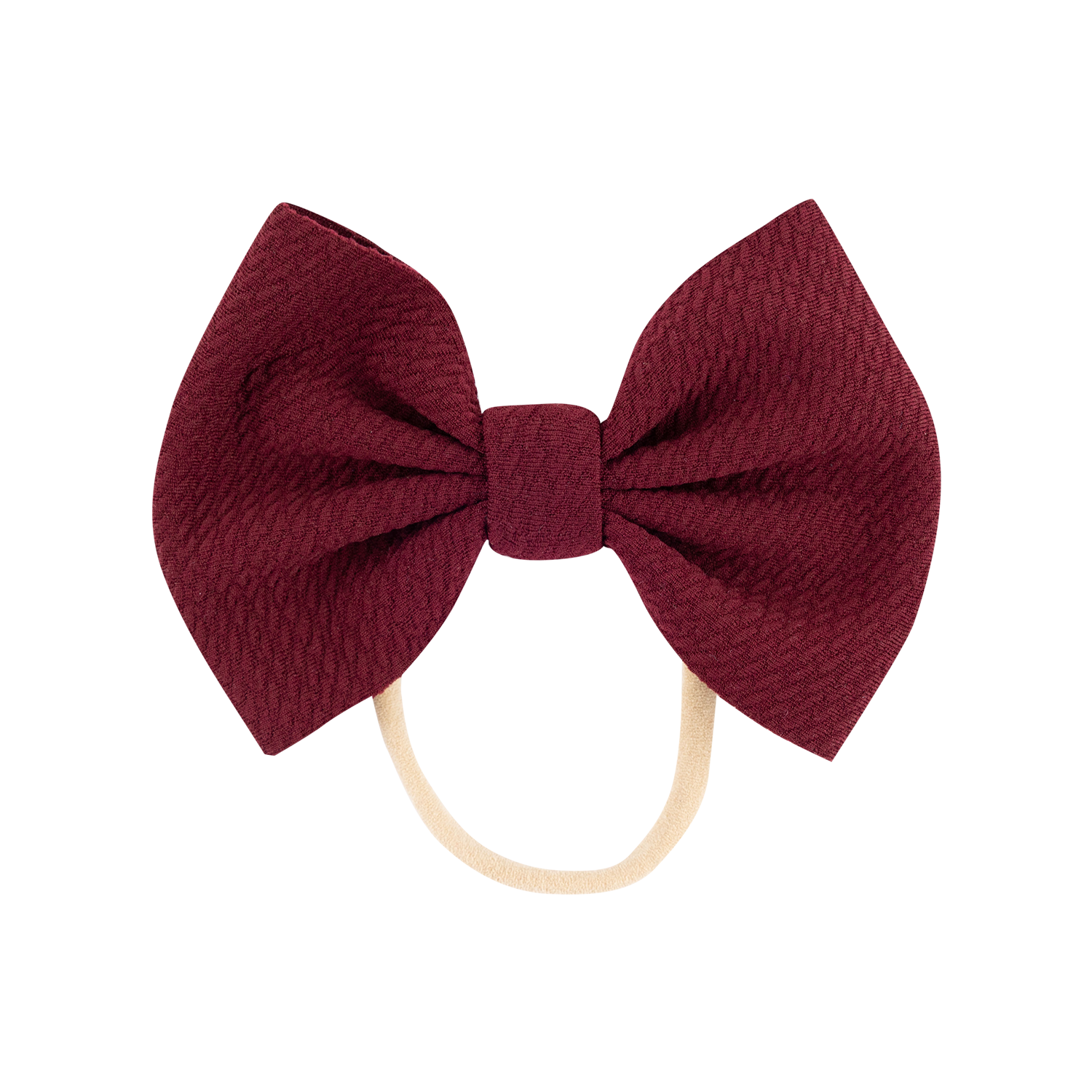 A bow headband featuring a textured burgundy fabric bow attached to a thin beige elastic head band, shown against a plain white background.