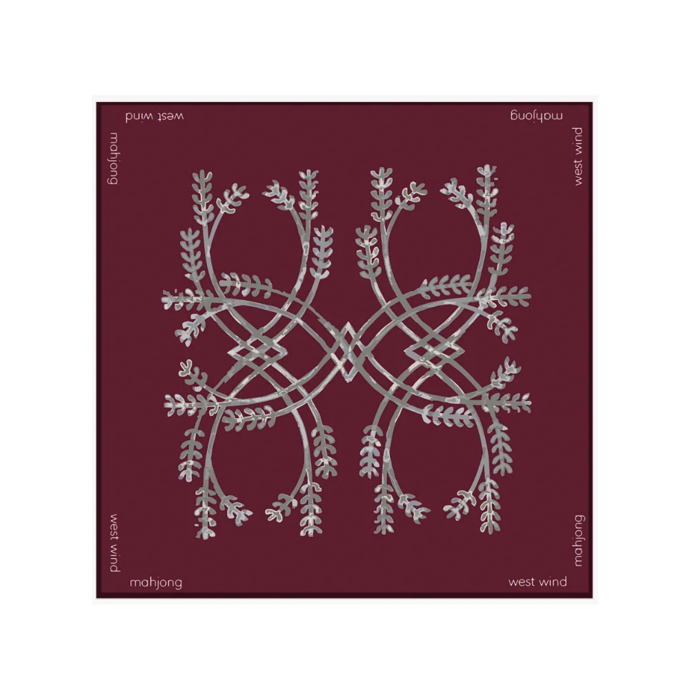 Maroon mahjong tile mat featuring an intricate symmetrical silver botanical design and white “Mahjong” and “West Wind” text around the border.