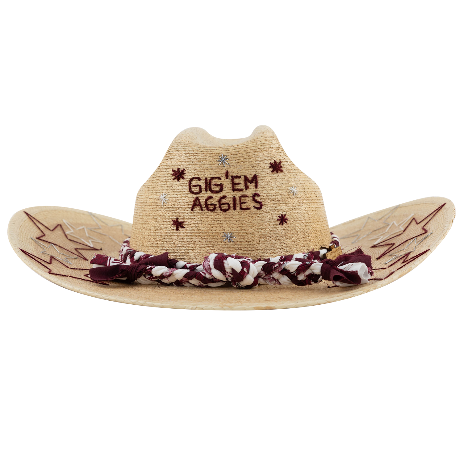 A tan straw cowboy hat embroidered with "GIG'EM AGGIES" in maroon thread on the front crown, surrounded by maroon and silver star accents. The brim features maroon and silver embroidered star and lightning-bolt designs, and the base of the crown is wrapped with a braided maroon-and-white fabric band.